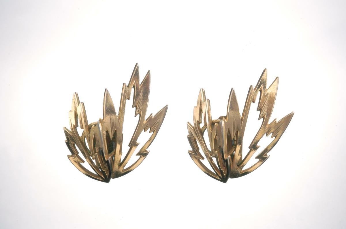 A pair of golden fire-like ear rings that belonged to a notable women's rights activist