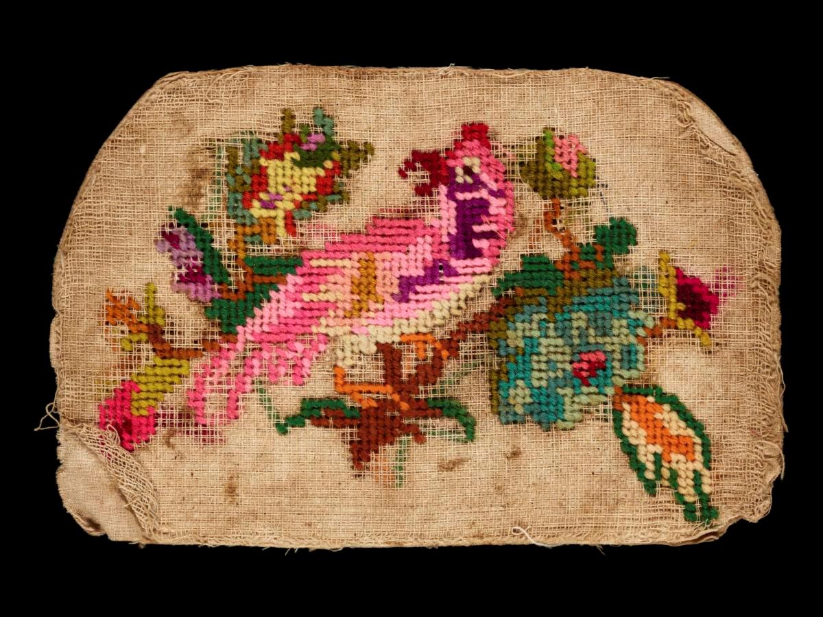 Needlework sampler with motif of a bird perching on a branch