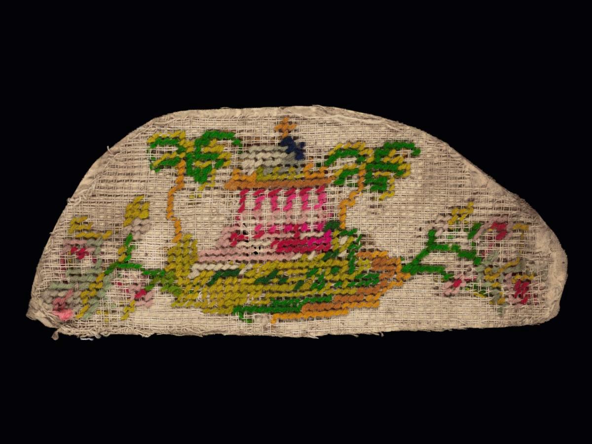 Needlework sampler with motif of a structure with flowers and trees