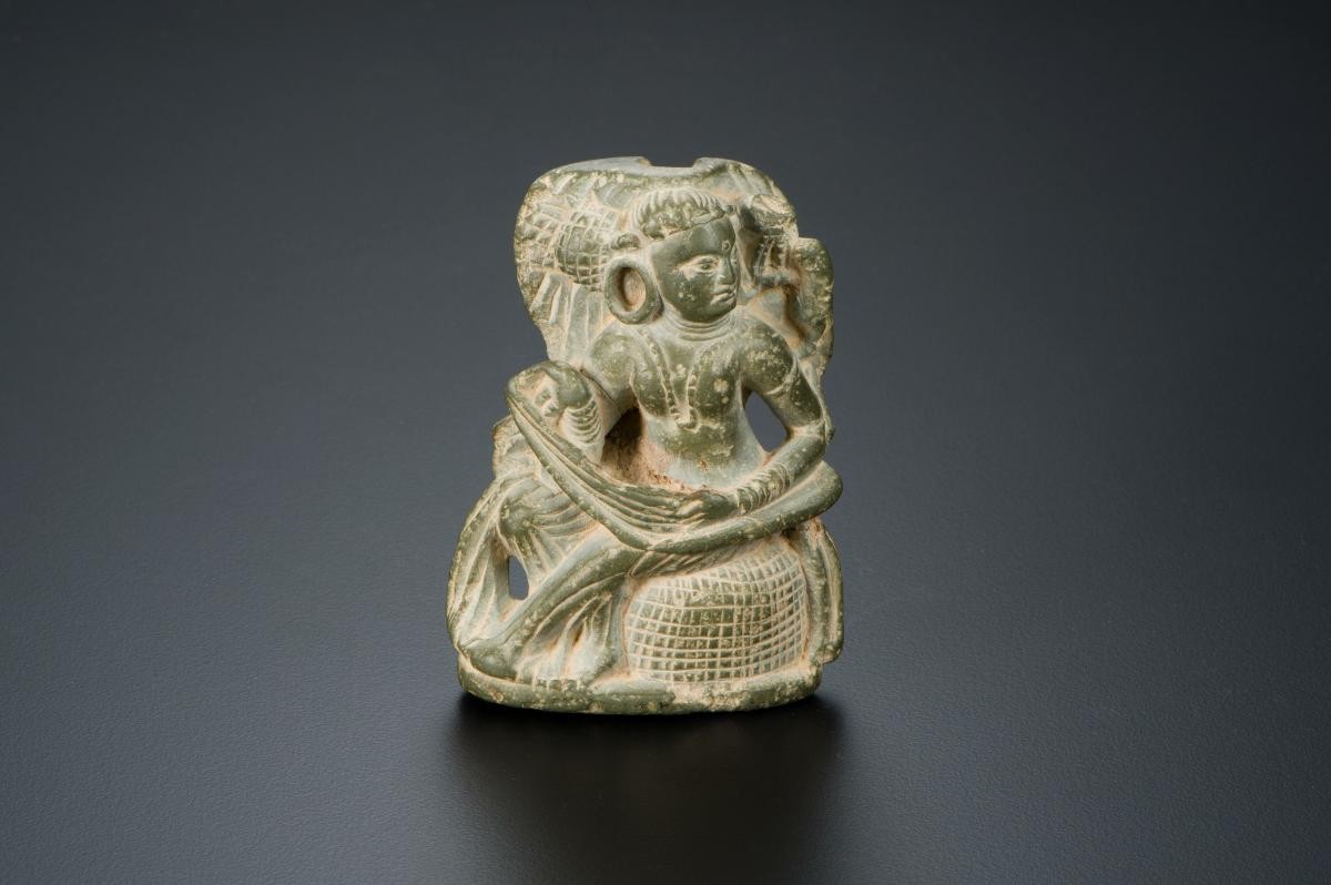 Mirror handle in form of a seated woman