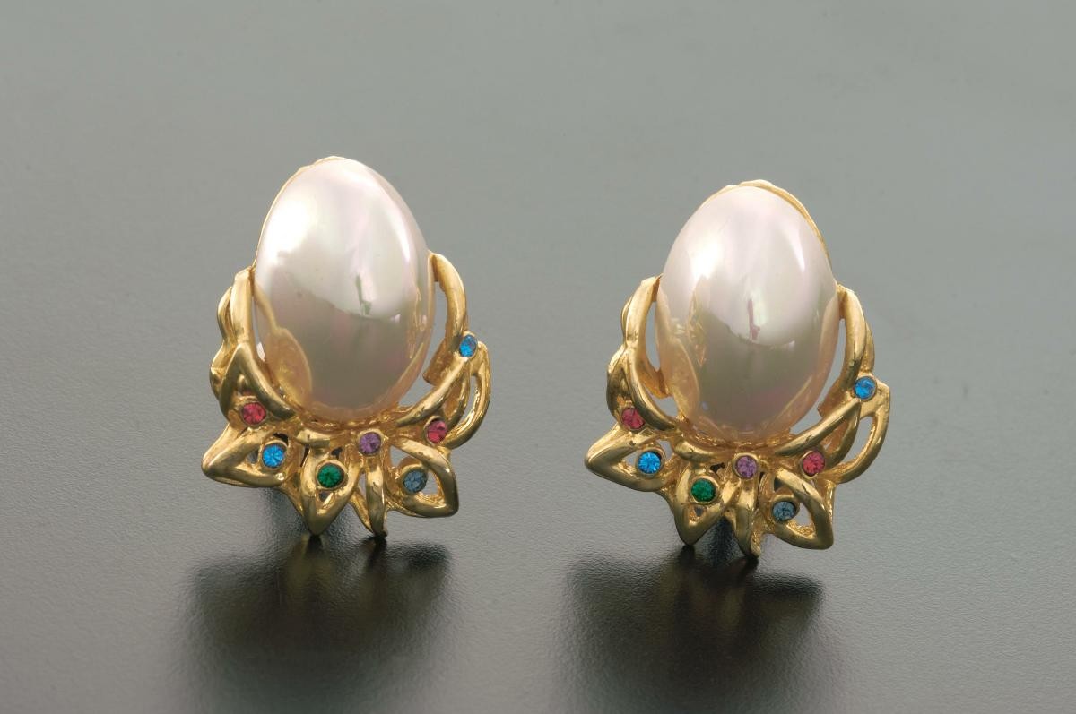 A pair of ear rings with pearls and blue and red crystals that belonged to a notable women's rights activist