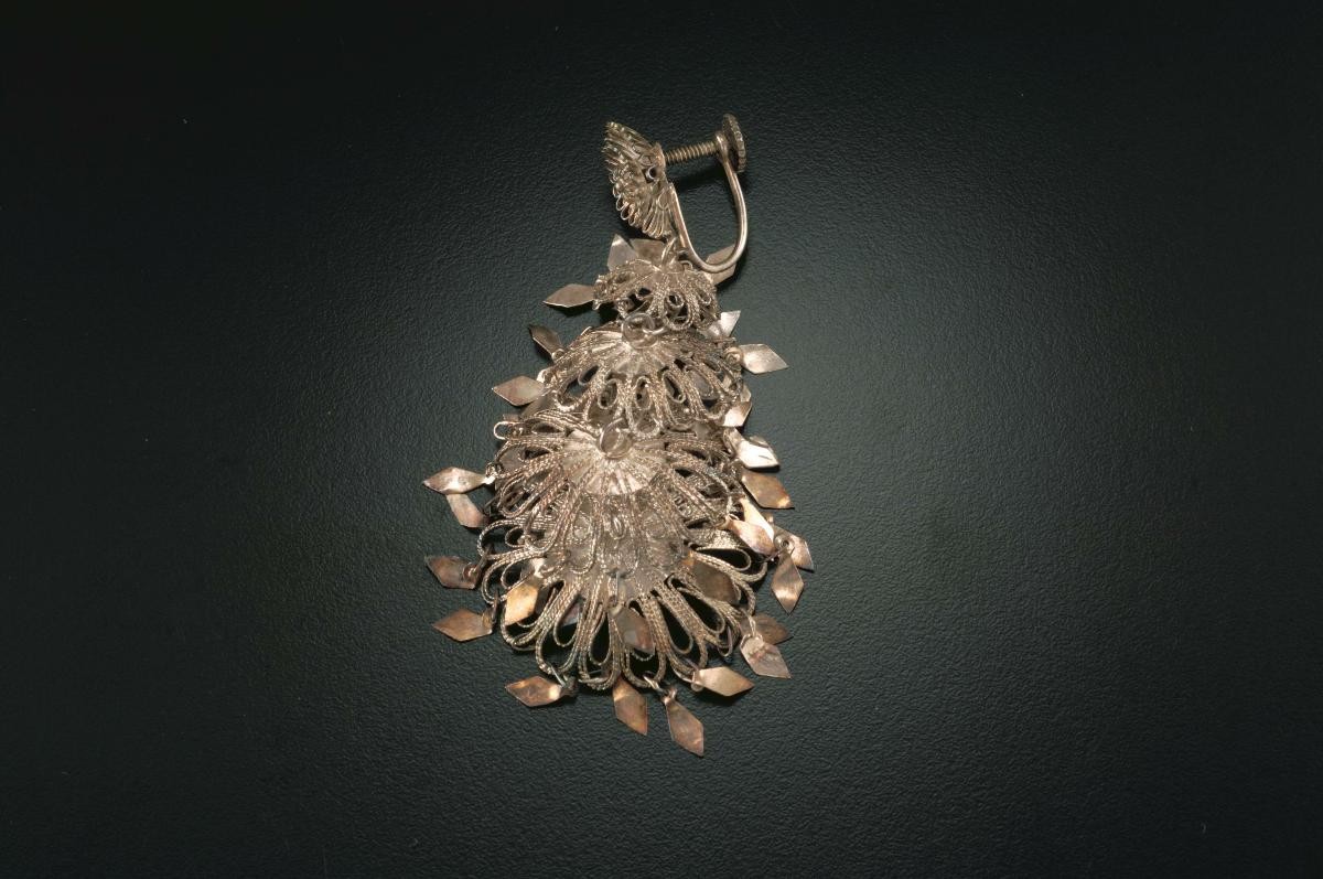 A pair of golden "coil-and-leaf" ear rings that belonged to a women's rights activist