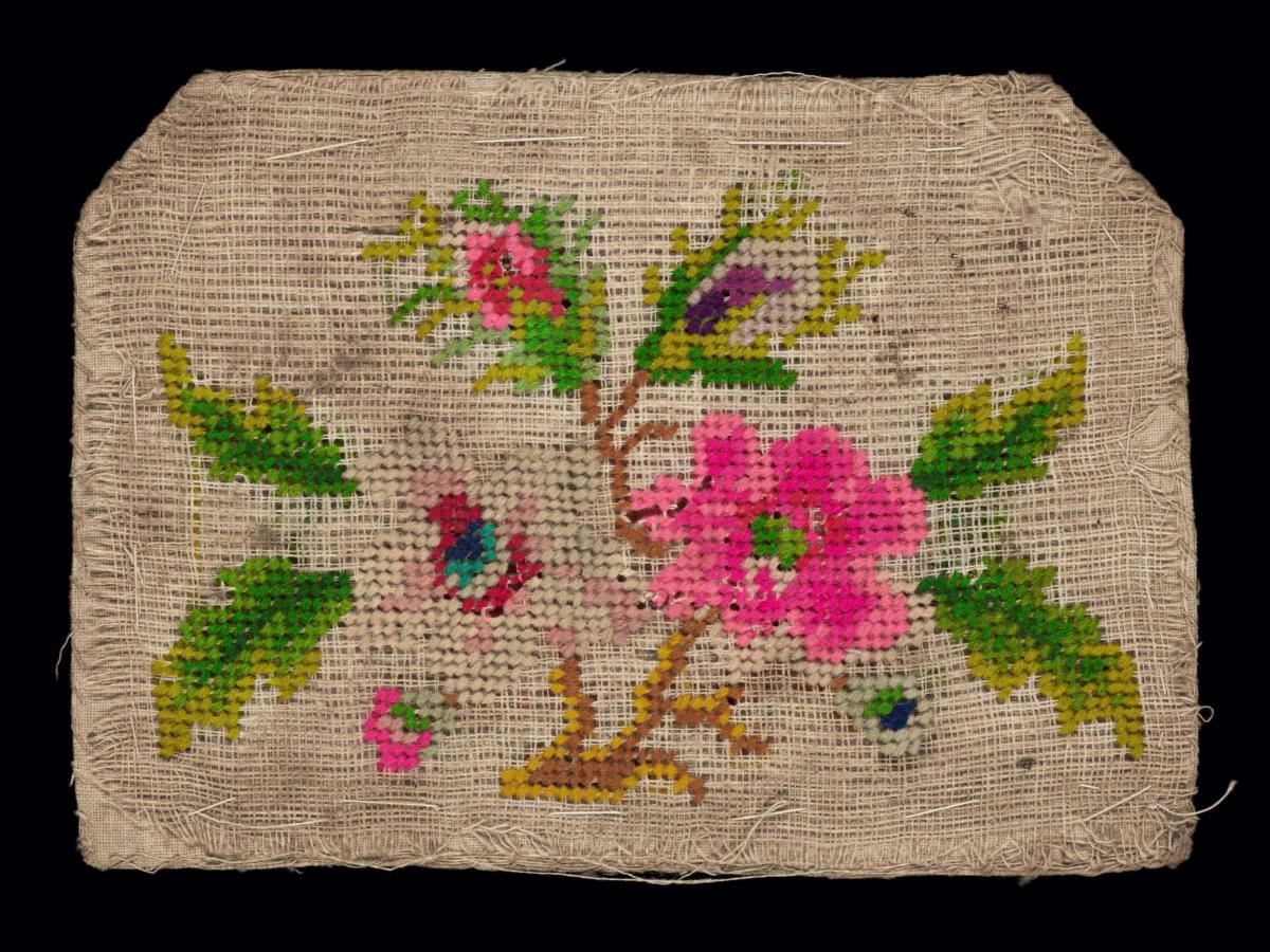 Needlework sampler with motifs of two flowers