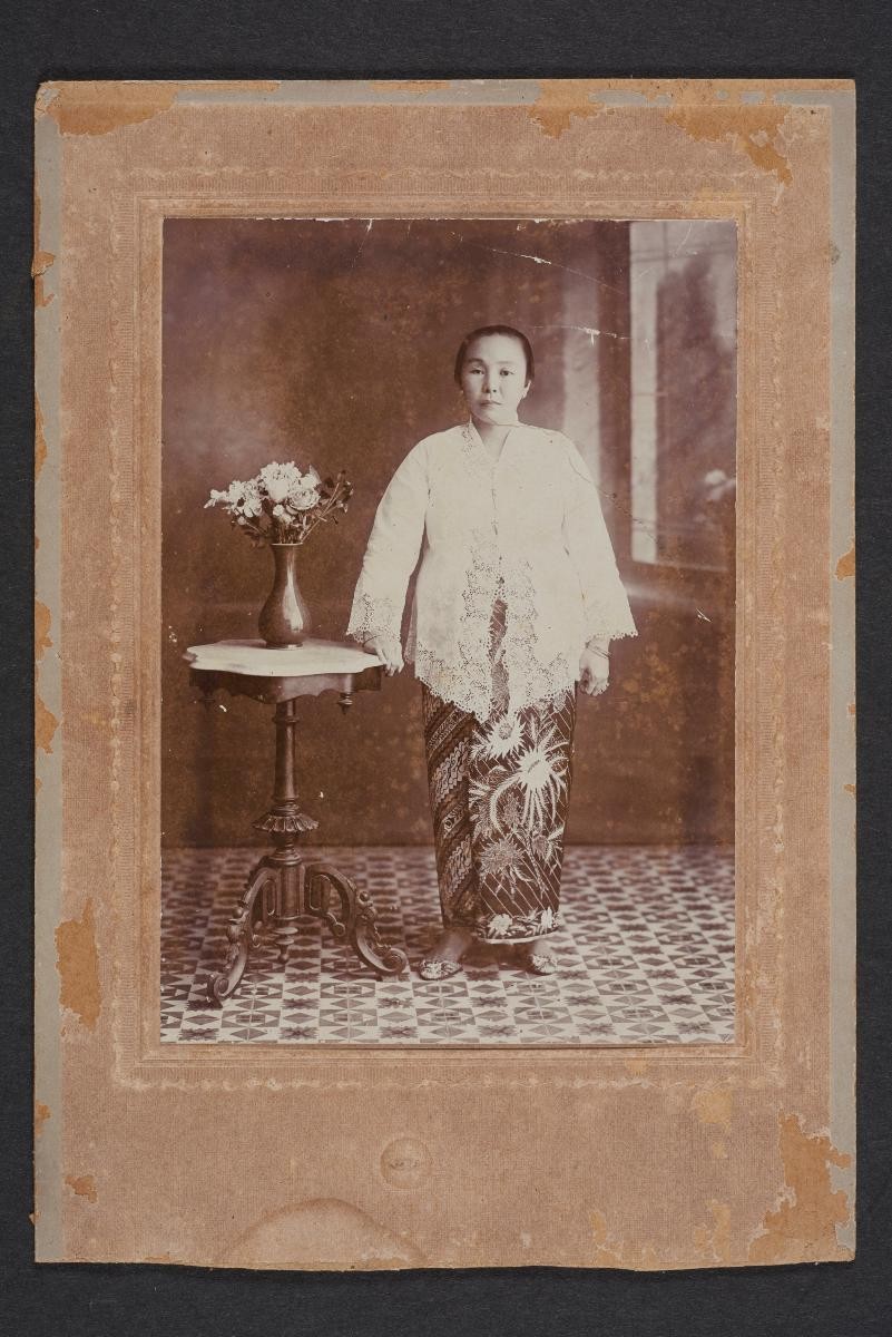 Lauw Fong portrait of a nyonya beside a vase of flowers