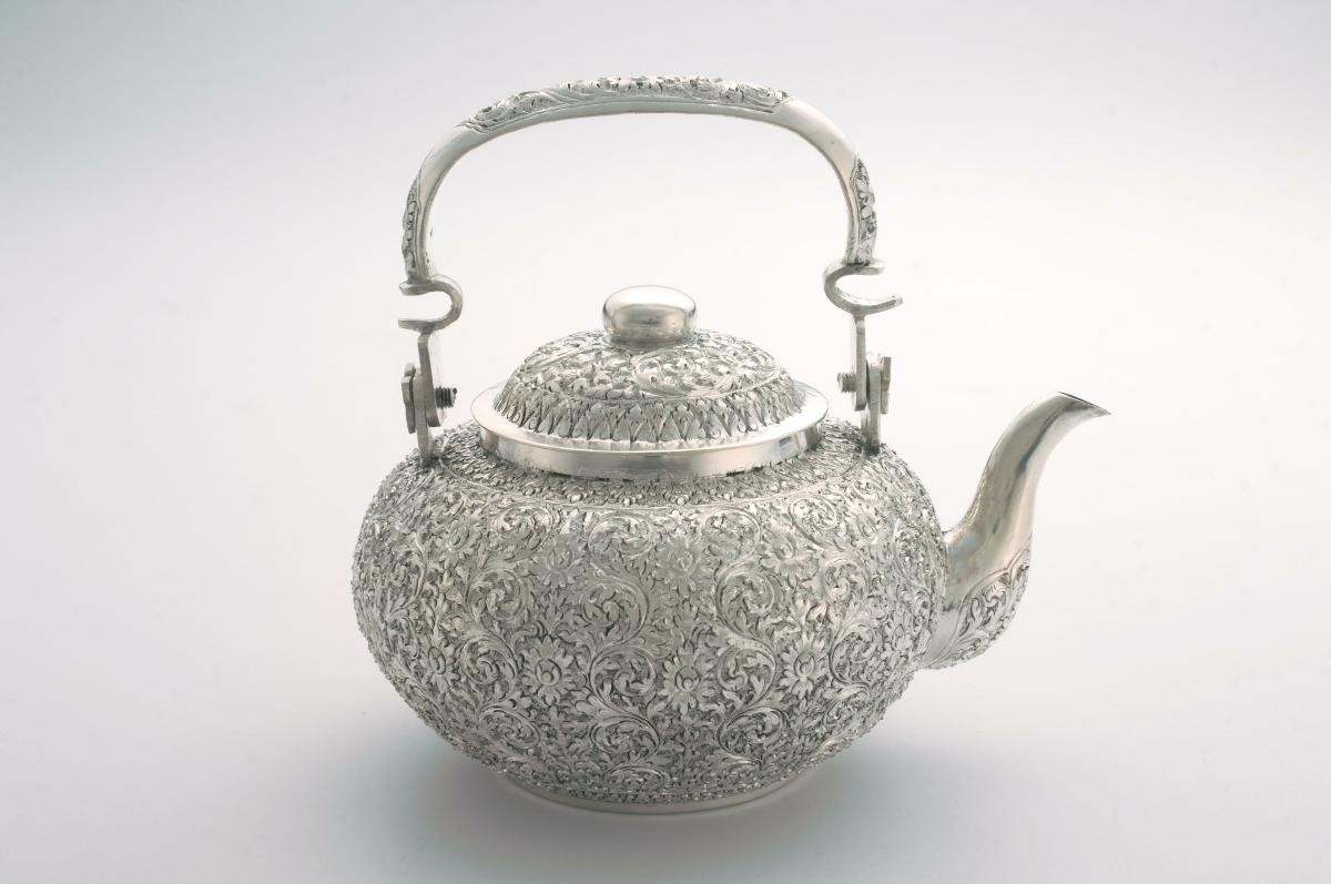 Silver teapot with floral repoussé design