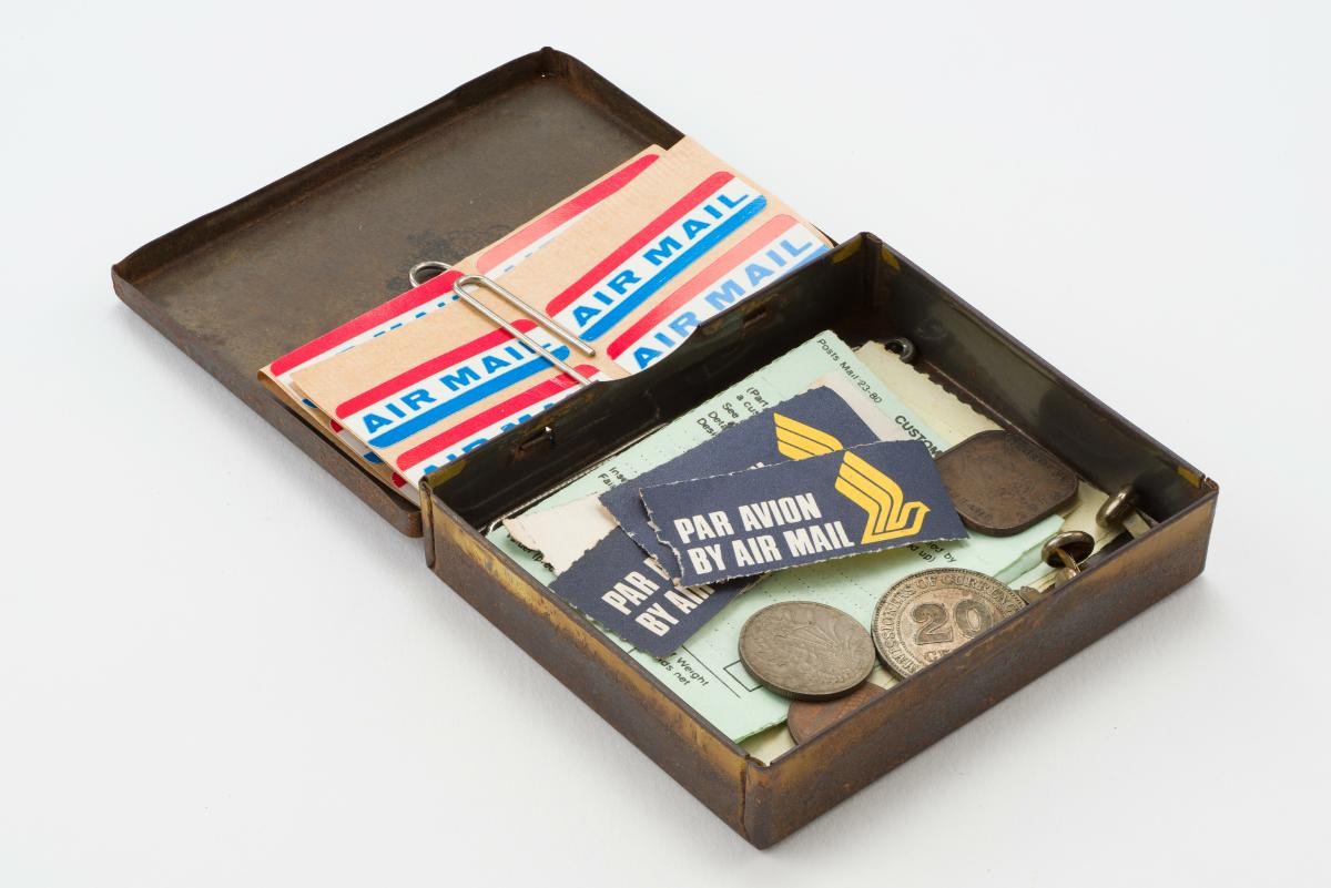 A Chettiar moneylender’s tin box containing postal stationery and assorted items