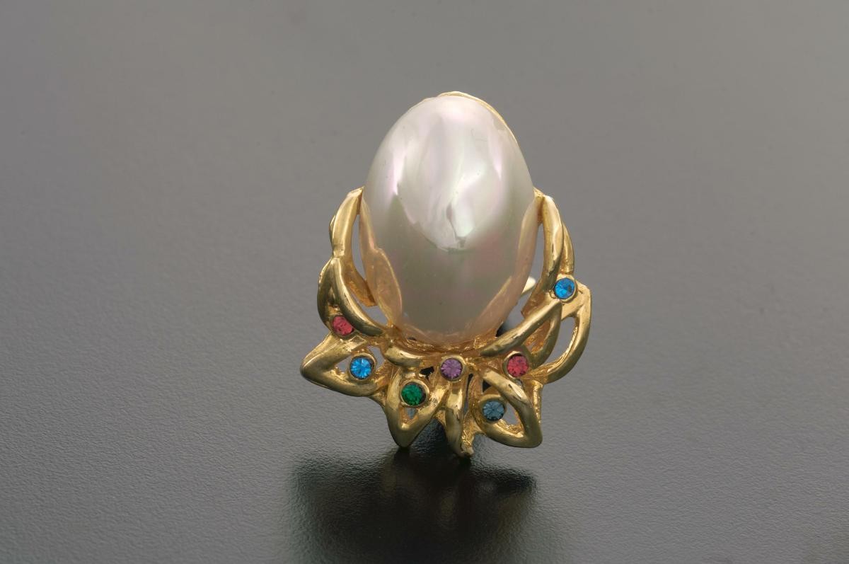 A pair of ear rings with pearls and blue and red crystals that belonged to a notable women's rights activist