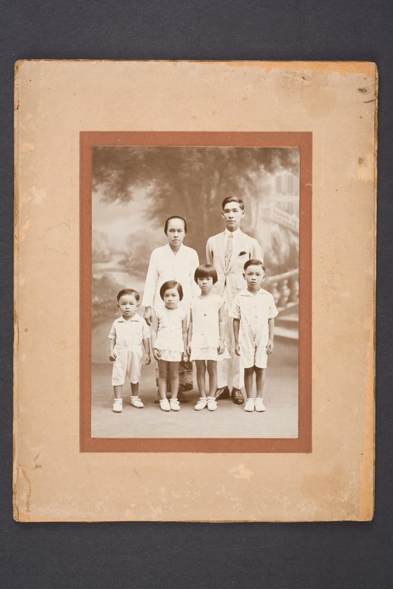 Studio portrait of Peranakan family with four children