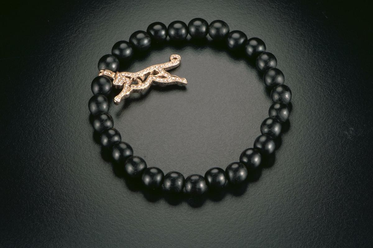 Charm bracelet with a tiger diamond pendant