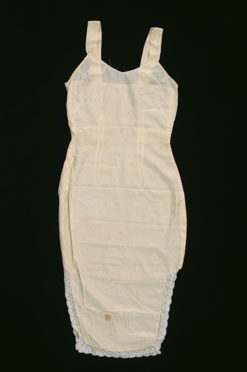 A yellow slip with straps and lace trimmings