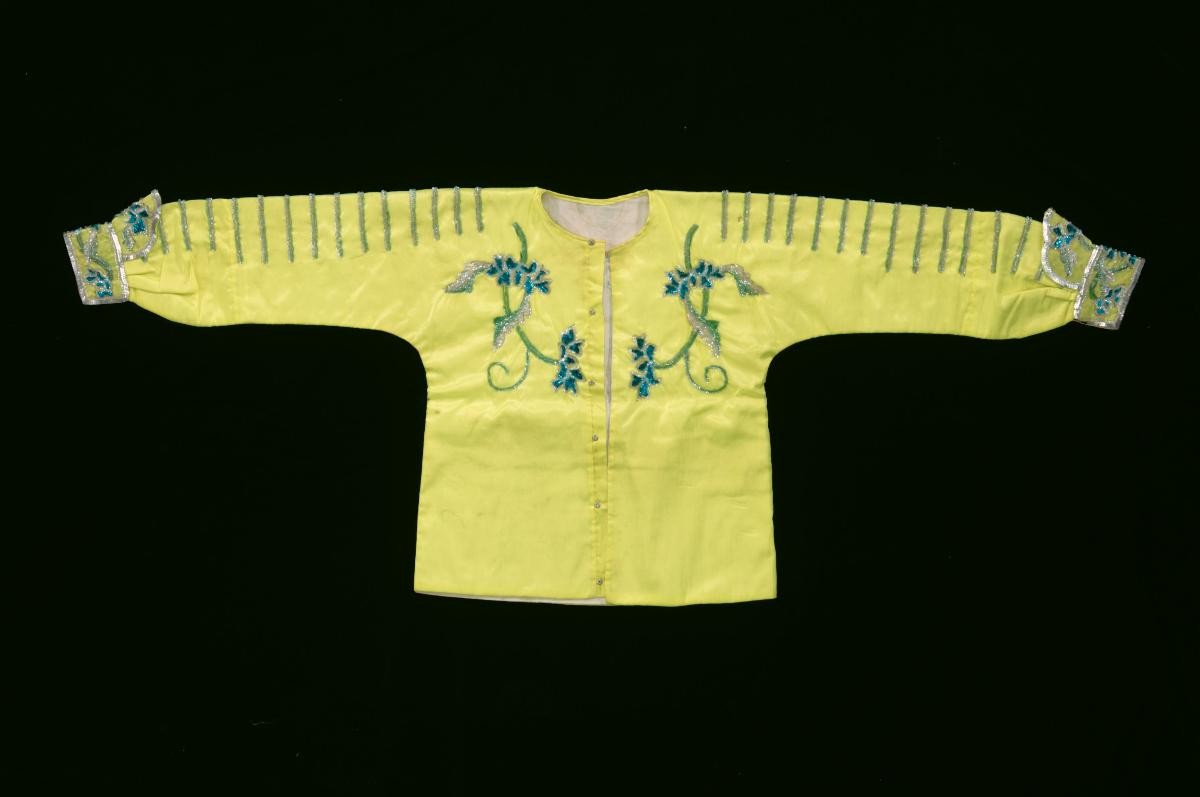 A yellow top with green floral sequins worn by a ‘wu dan’ in a Chinese opera