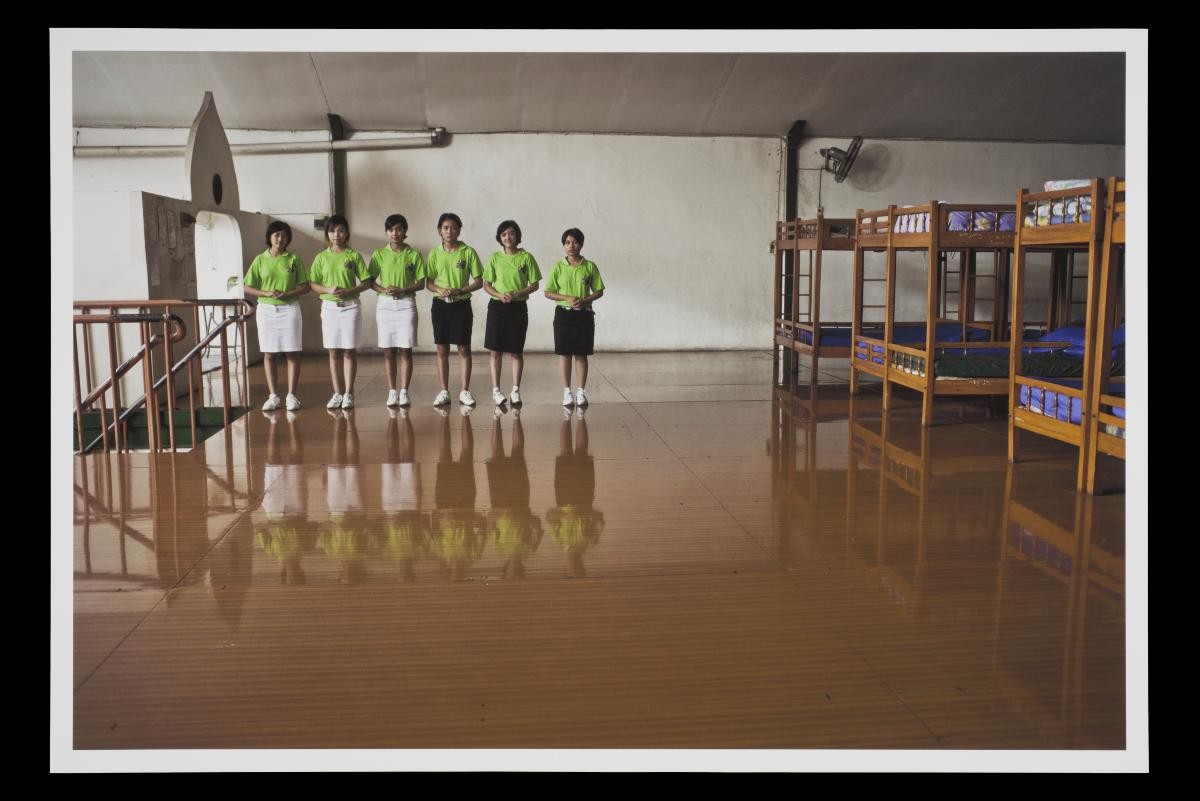 Photograph of Indonesian domestic workers decked out in their uniform at a training centre