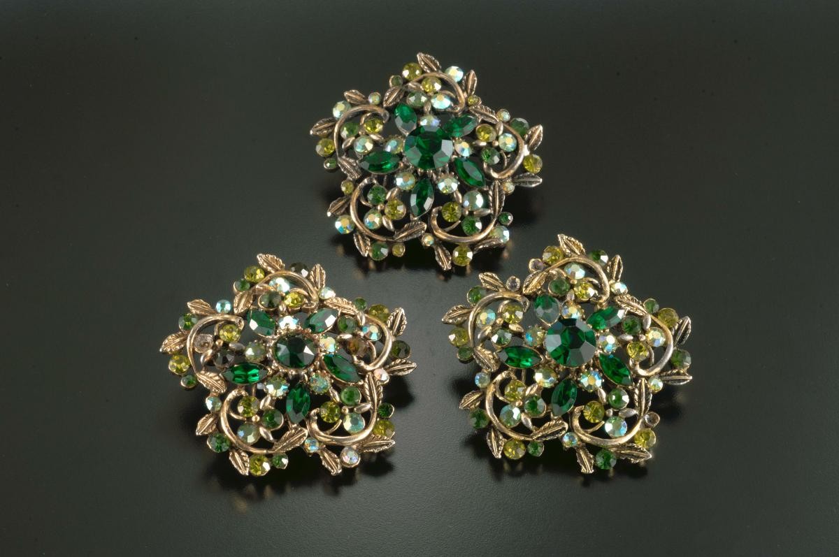 A set of three green diamanté brooches that belonged to a notable women's rights activist