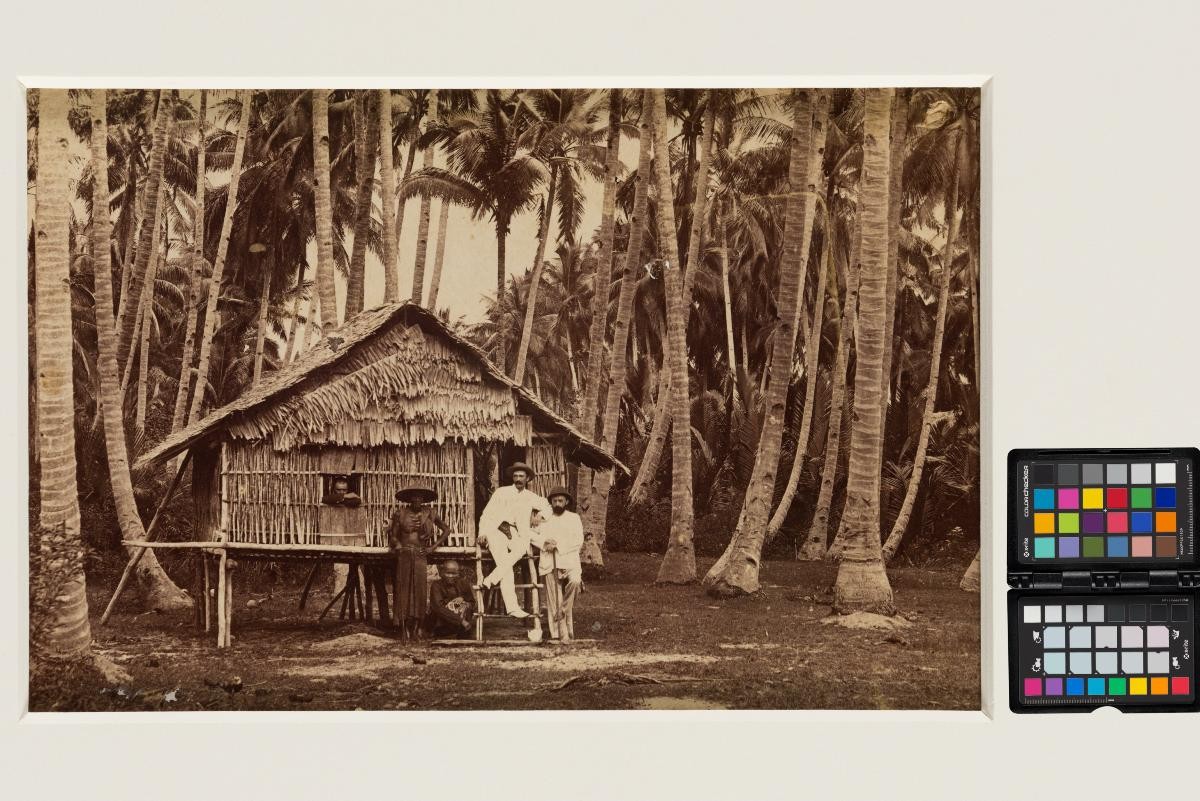 European men at 'attap' house in jungle