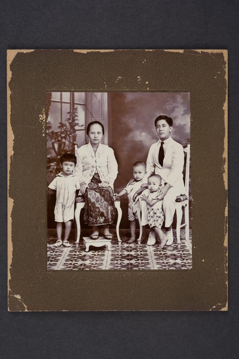 Studio portrait of peranakan family with three children