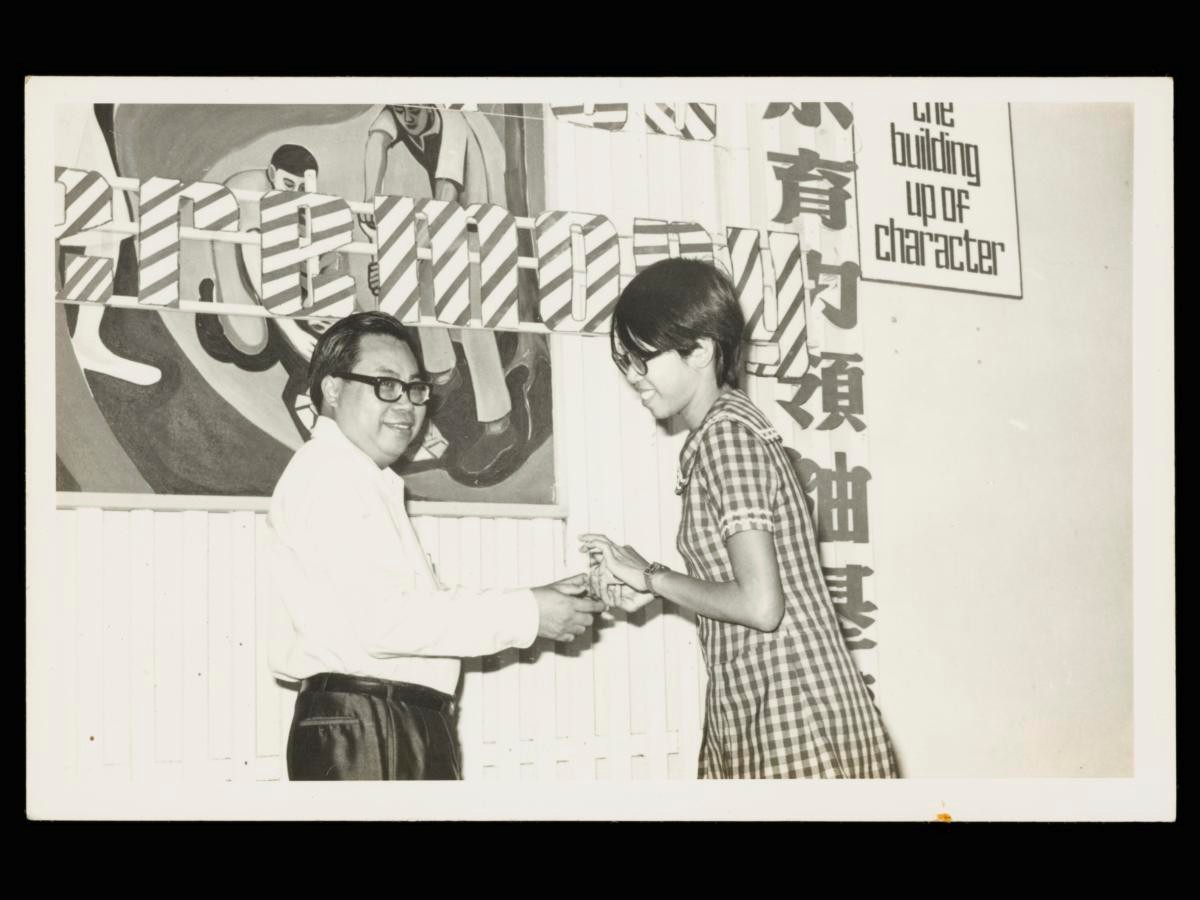 Loo Karn Moon receiving National Youth Leadership Training Institute certificate from Lee Wai Kok