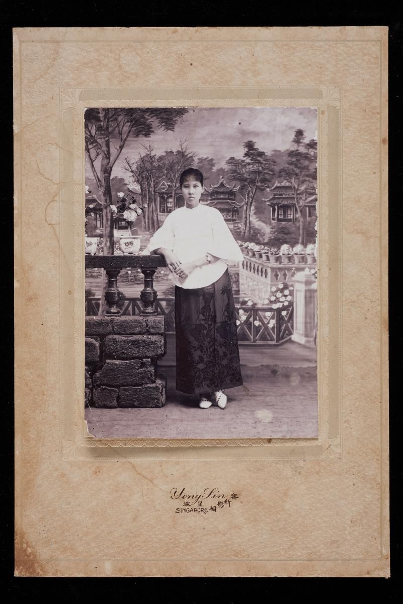 Studio portrait of a Chinese woman with a Chinese garden backdrop