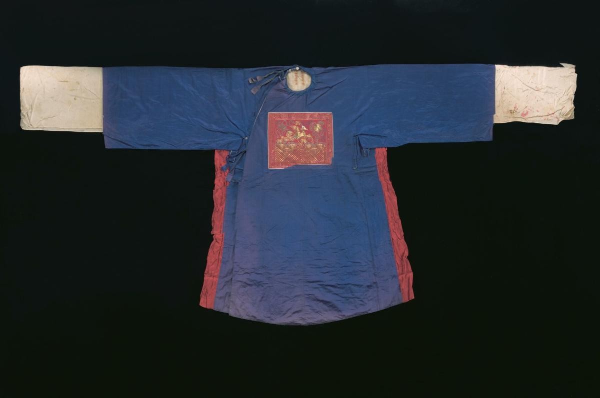 A dark blue robe with a red insignia worn by a court official in a Chinese opera