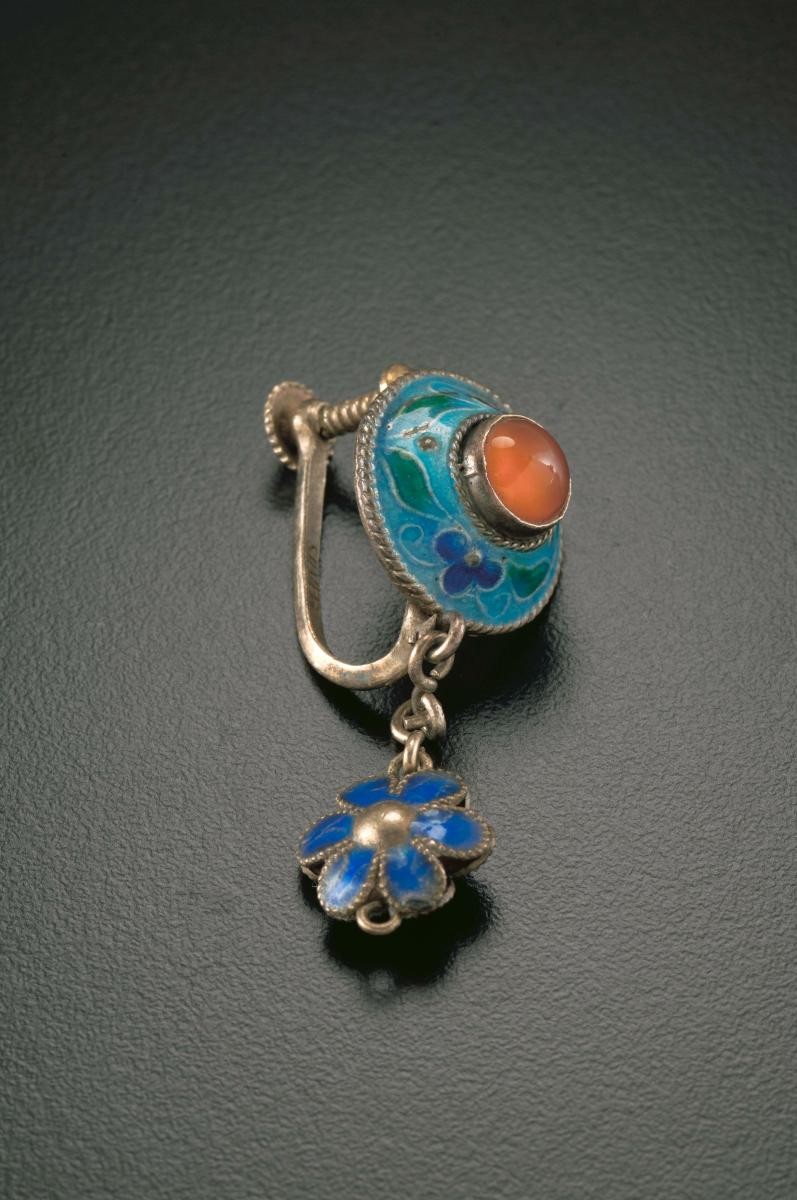 A pair of ear rings with pink and turquoise blue stones that belonged to a women's rights activist